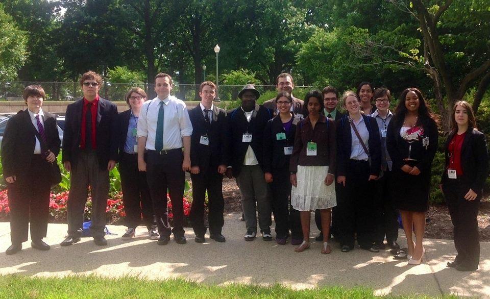 Photo of a group of ACI Summer Leadership academy attendees outside, dressed in business attire